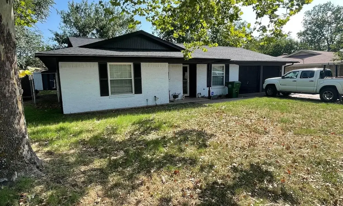 Professional roofing crew working on a residential roof in Groton